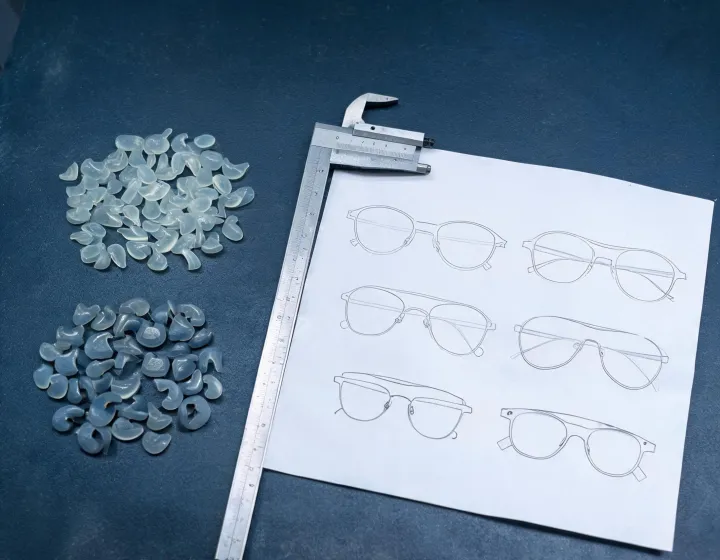 Custom nose pads for glasses sizing notes on a sourcing desk